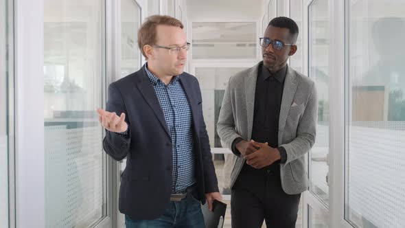 Caucasian Man Introducing to African American Guy New Office