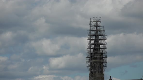 A church tower surrounded by scaffolds in French village