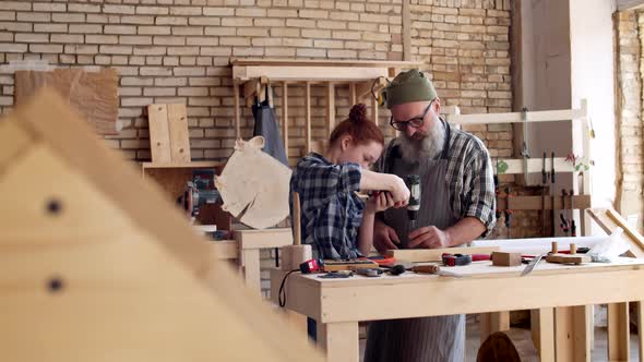 Granddad and Granddaughter Working in Joinery alt