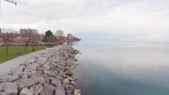 Smooth sunset aerial by the edge of the Burlington Ontario Lake. Half water half land. Five meters a alt