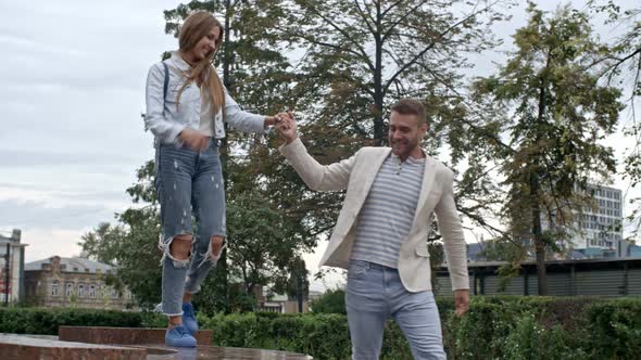 Beautiful Woman Walking at Fountain with Boyfriend alt