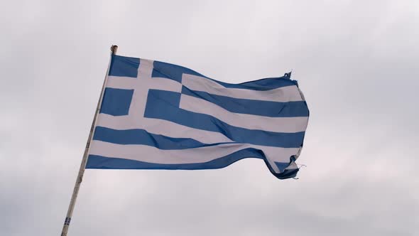 Greek Flag on the Pillar Waving on the Wind Over Sky Background alt