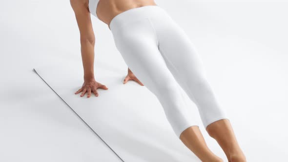 Senior Woman in White Space Practice Yoga Lifted Up Her Body in a Bridge Pose