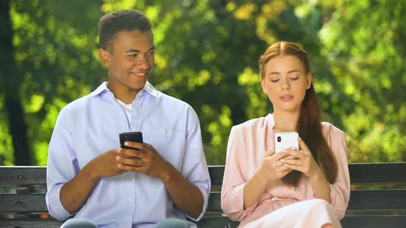 Mixed-Race Boy Making Compliment to Gadget-Addicted Girl in Social Network, Fail alt