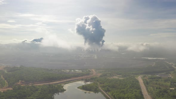 Coal-fired power plants that steam into the atmosphere from the chimney.