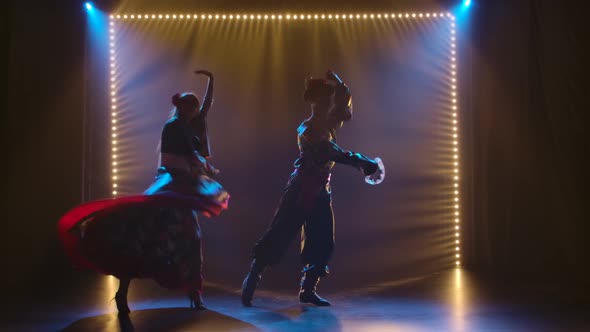 Passionate Couple Dancing Qigang Folk Dance in Costumes, Theatrical Dance Show, Silhouettes of alt