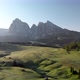 Flying backwards above blooming fields meadows at Alpe di Suisi  in Dolomites Italy - VideoHive Item for Sale