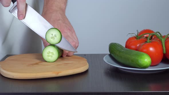 Cooking Salad. the Cook Cuts the Cucumbers