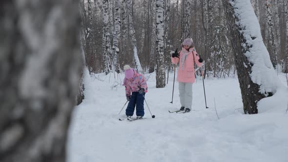 Woman with Little Daughter Cross Country Skiing alt