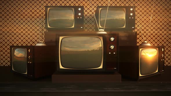 An exhibition of old-fashioned retro color tv sets with tuner antennas.