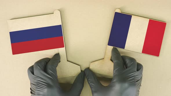 Flags of Russia and France Made on the Cardboard Table