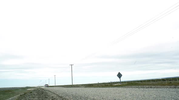 Suv Car On Dirt Road near Power Lines, in Patagonia, Argentina. alt