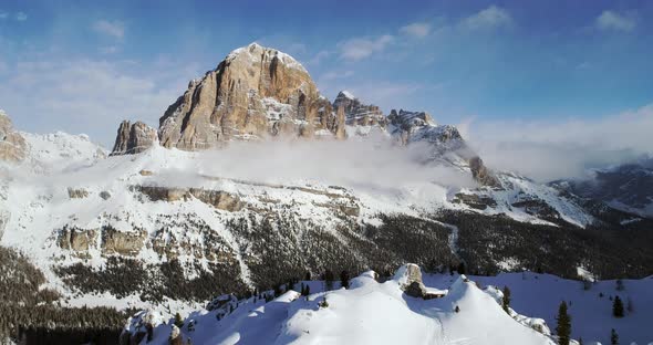 Forward Aerial to Snowy Alpine Valley with Woods Forest at Cinque Torri alt