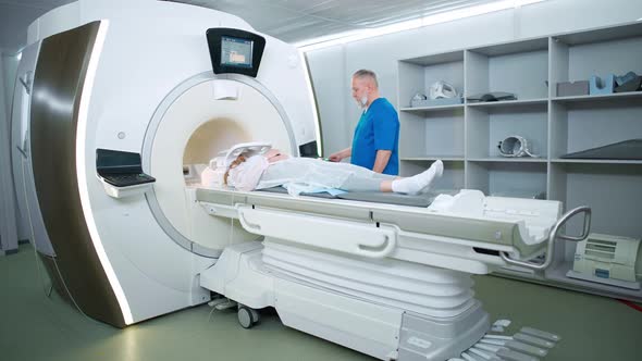 Magnetic Resonance Imaging in the Modern Hospital Adult Man Doctor Performs a Magnetic Tomographic alt