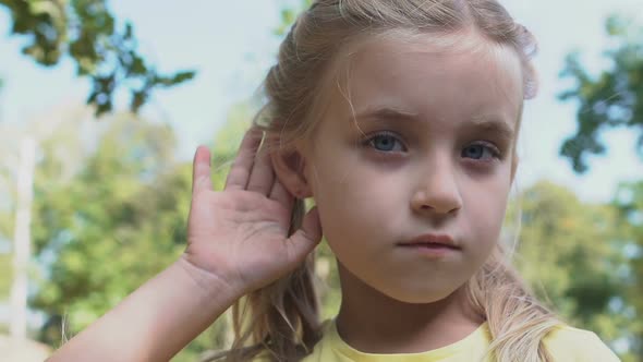 Cute Caucasian Girl Holding Hand Near Ear Making Listening Gesture, Gossip News