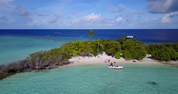 Luxury fly over copy space shot of a white paradise beach and blue ocean background in 4K alt