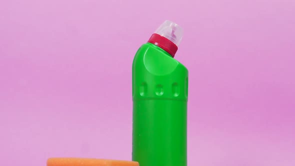 A Plastic Bottle of Cleanser Latex Gloves and a Cleaning Cloth