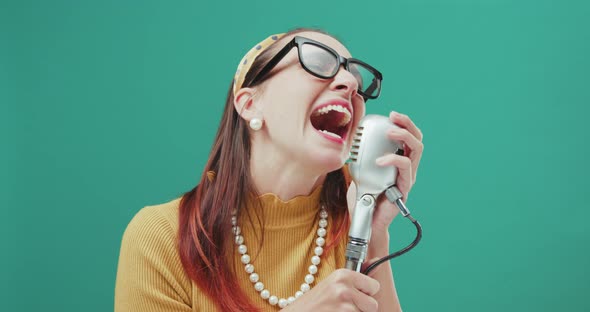 Vintage style woman singing with a microphone