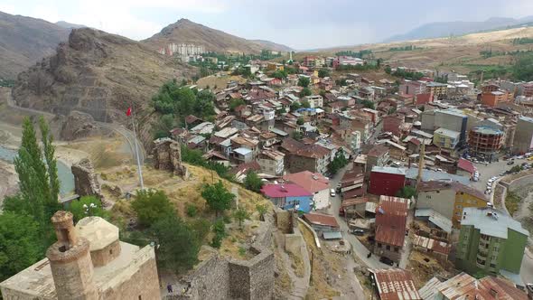 Old Fortress Walls and Watchtower of Castle Behind the Houses in the Small City alt