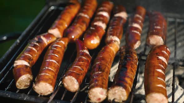 Grilling Tasty Sausages on Barbecue Grill