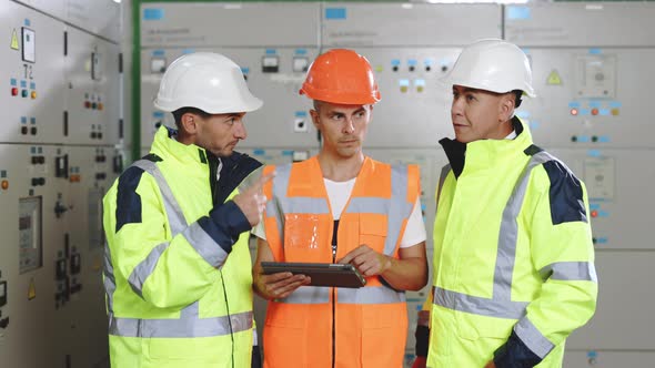 Engineers With Digital Tablet Do Pre Commissioning Works Inspecting Electrical Station