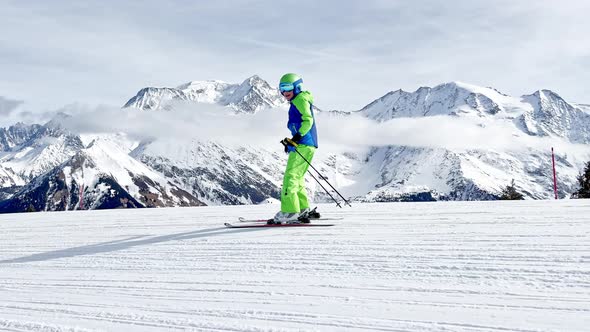 Profile Shot of Boy Ski Fast Downhill Over Beautiful Mountains alt
