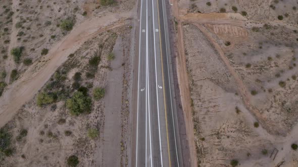 Aerial pull-back over a crossroads in the desert alt