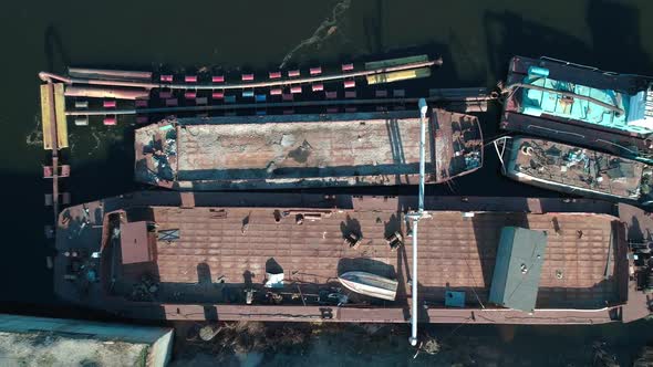 Aerial View Above Old Abandoned Cargo Ships, Dolly Shot Top View