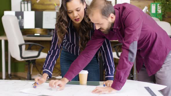 Team of Architects in the Office Talking About New Bulding Development alt
