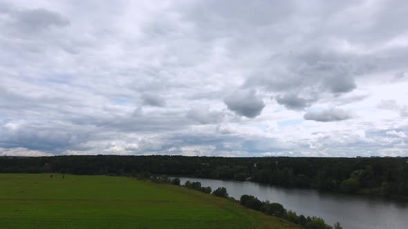 Mustard flower fields bird's-eye view. Copter. Drone. Motion. River flow.