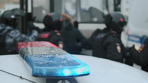 Policemen Checking Fugitives Before Packing in Paddy Wagon alt