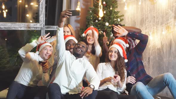 Smiling Group Of Friends Celebrate Evening Event With Selfie At Christmas Party