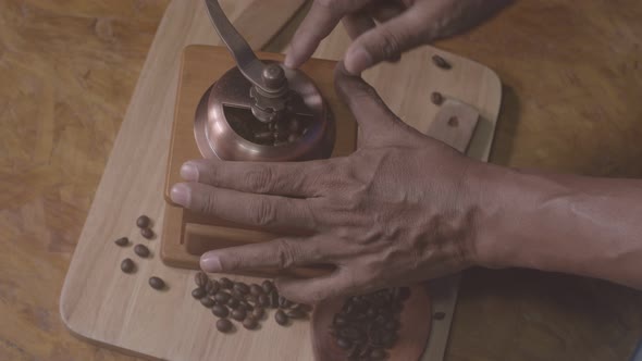 Manual Coffee Grinder Placed On A Wooden Floor. alt