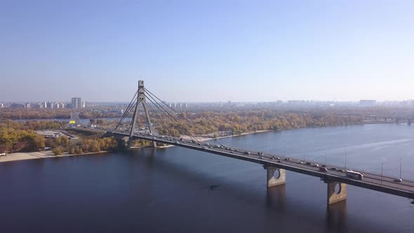 Aerial: Traffic on Pivnichniy bridge in Kiyv, autumn time alt