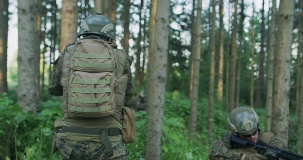 Soldiers in the Smoke Moving in Battle Operation Thorugh Dense Forest alt