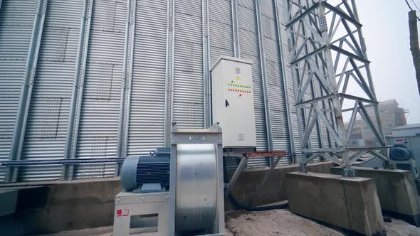 Work of an elevator with a generator. Steel grain silos for grain storage. Grain storage elevators w alt