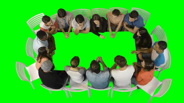 Group of business executives discussing in meeting alt