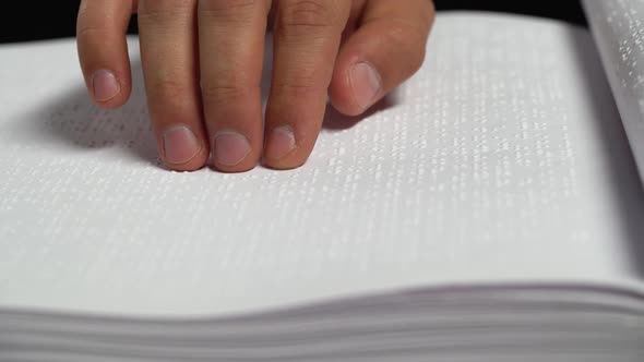Male Hands Reading a Braille Book. Close Up alt
