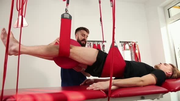 Orthopedic Doctor Makes a Diagnosis of the Muscle Tone on Legs alt