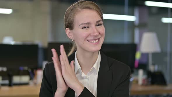 Portrait of Happy Young Businesswoman Clapping alt