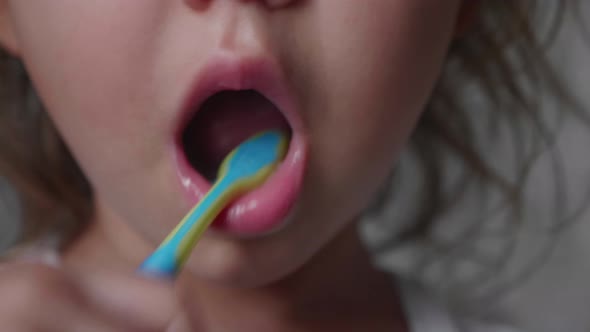 Closeup Mouth of Little Child Girl is Brushing Her Teeth with Toothbrush alt