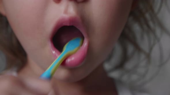 Closeup Mouth of Little Child Girl is Brushing Her Teeth with Toothbrush
