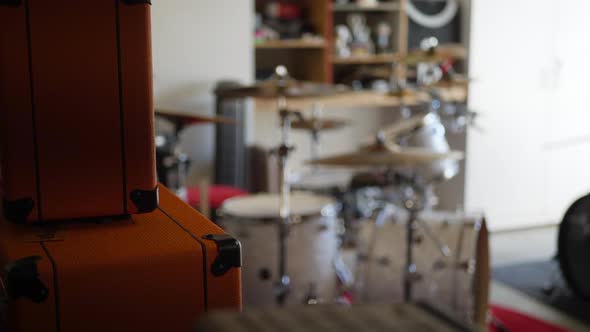 A rock and roll garage band practice with guitar amp, drum set and music gear. alt