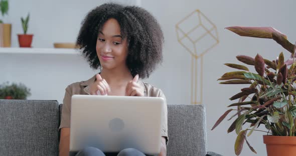 Young Girl Holds Meeting, Conference Online Sitting at Home in Room in Office on Couch, Quarantine alt