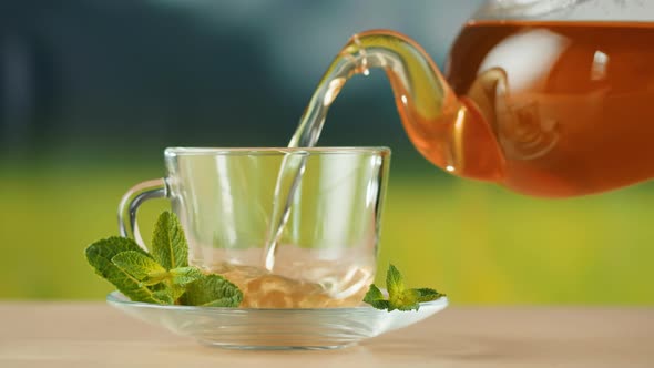 Pouring Hot Tea in Cup Closeup alt