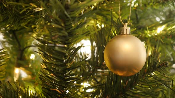 Golden matte color  Christmas ornament 4K 2160p 30fps UltraHD footage - Sparkling lights and bauble  alt
