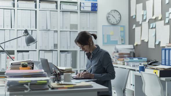 Efficient businesswoman working in her office