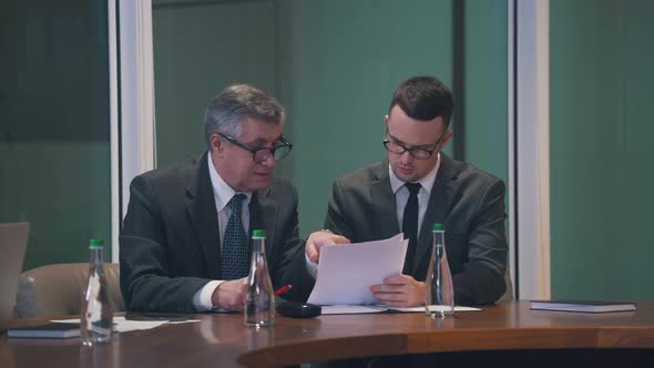 the Investor Explains the Data to His Partner in the Office alt