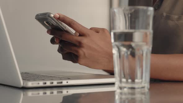 Closeup of Female Mixed Race Black Woman Hands Texting in Smartphone, Procrastinating at Work