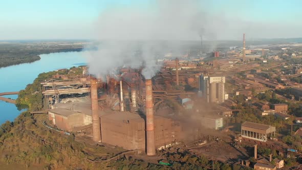 Aerial View of the Industrial Plant with Smoking Pipes Near the City. Industrial Zone alt